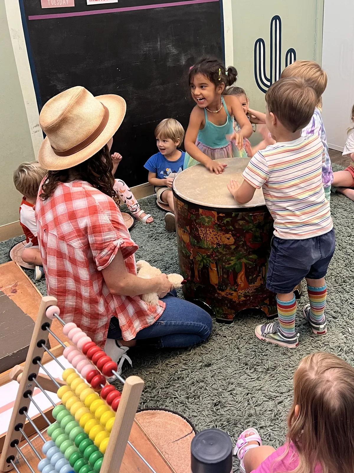 Kids playing a drum together at Green Sprout